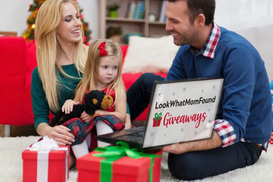 Family sitting together at Christmas, viewing LookWhatMomFound Giveaways on a laptop with festive gifts around.
